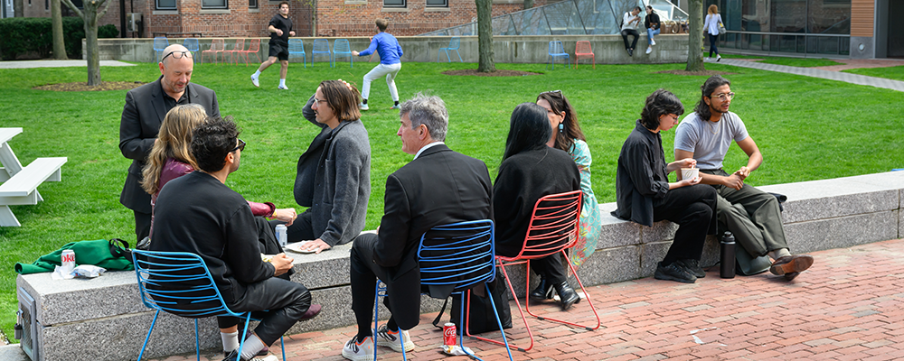 people sitting outside on campus grounds