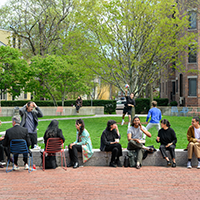 students and faculty sitting outside